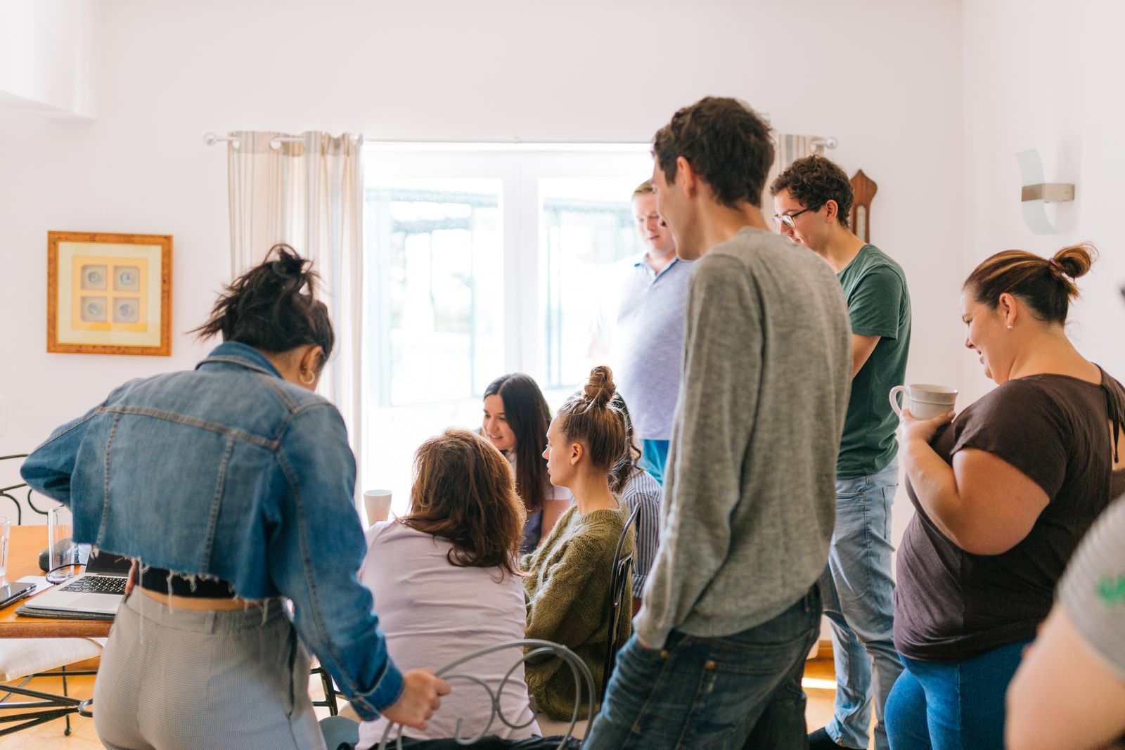 A group gathered around a laptop, working together